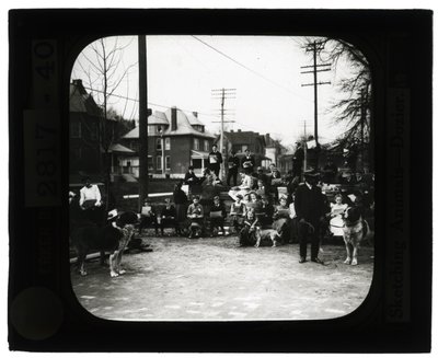Horizontal, black and white photo of students drawing dogs in an outdoor classroom setting by Unknown